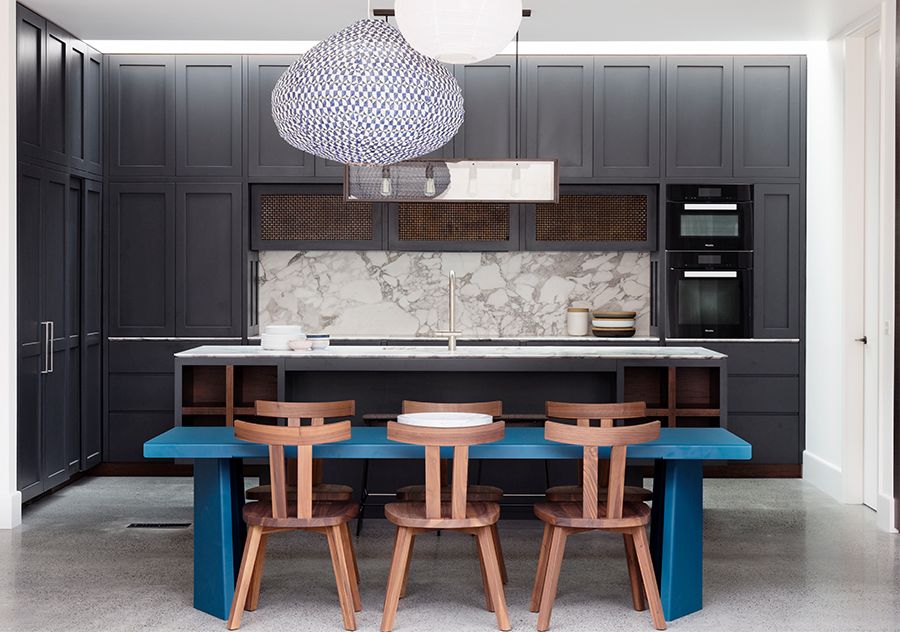 Dining table brings gorgeous blue to the black and white modern kitchen of the Aussie home