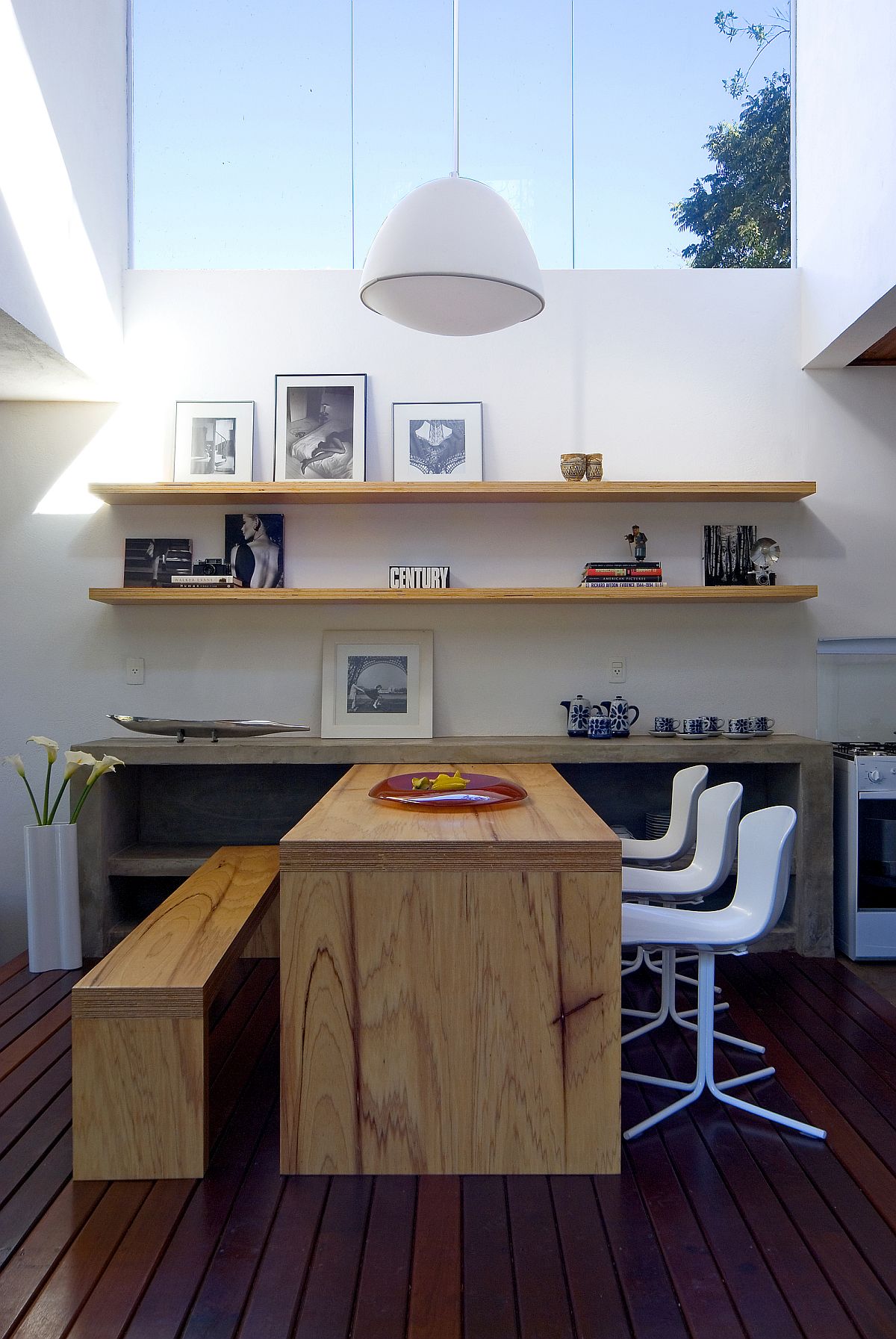 Double-height interior of the house is illuinated beautifully with skylights and pendant lights