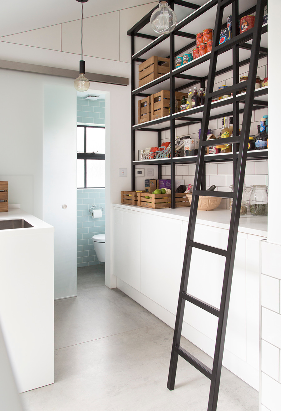 Edison bulb lighting for the industrial styled pantry with simple shelving