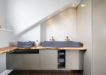 Ewe-wood-worktops-combined-with-granite-washbasins-inside-the-opulent-bathroom-31006-217x155
