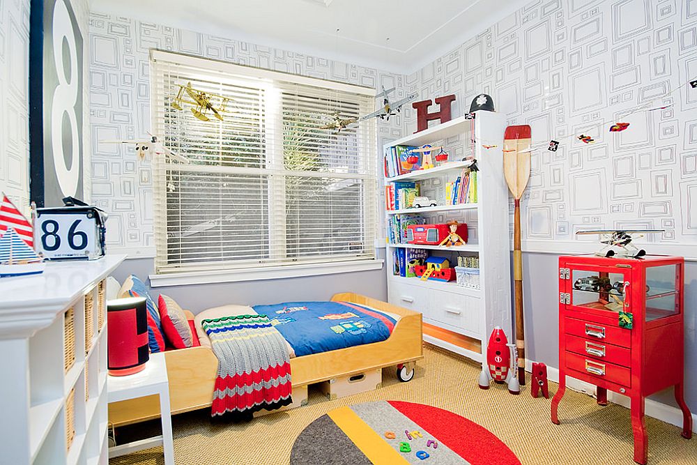 Fabulous kids' bedroom in white with a bed on wheels and plenty of red all around!