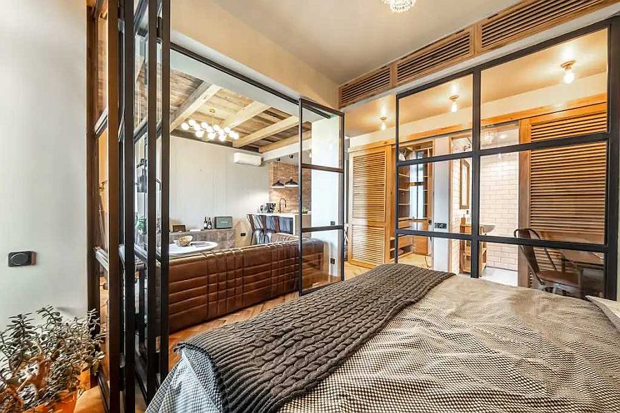 Framed glass walls surround the bedroom and separate it from the living area