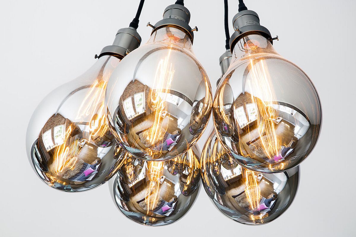 Gorgeous Edison bulb lights accentuate the industrial appeal of the loft master suite