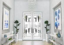 Gorgeous-cascading-chandelier-lights-up-this-large-entry-in-white-with-greenery-and-pops-of-blue-94936-217x155