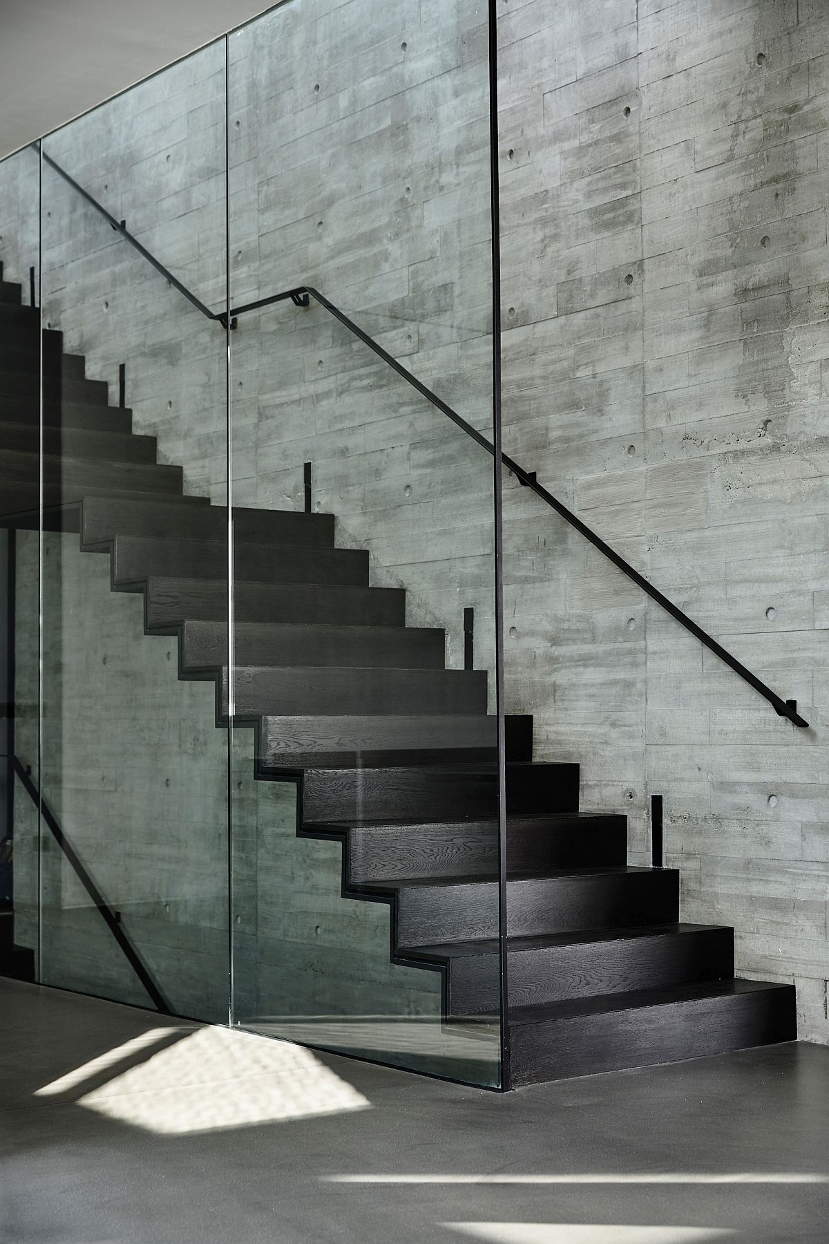 Gray coupled with raw concrete finishes inside the apartment