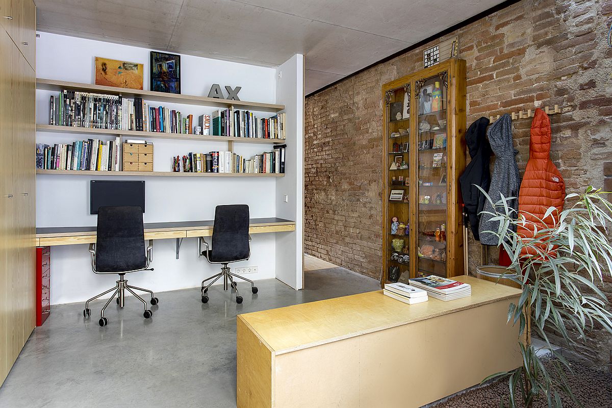 Home office of the residence with a modern workspace and beautiful brick walls