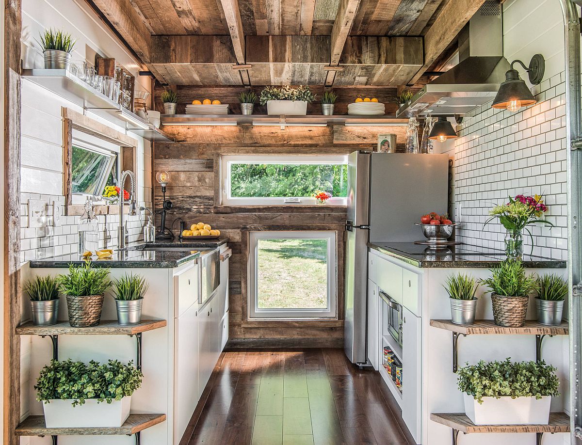 It is hard to miss all the greenery in this small industrial style kitchen