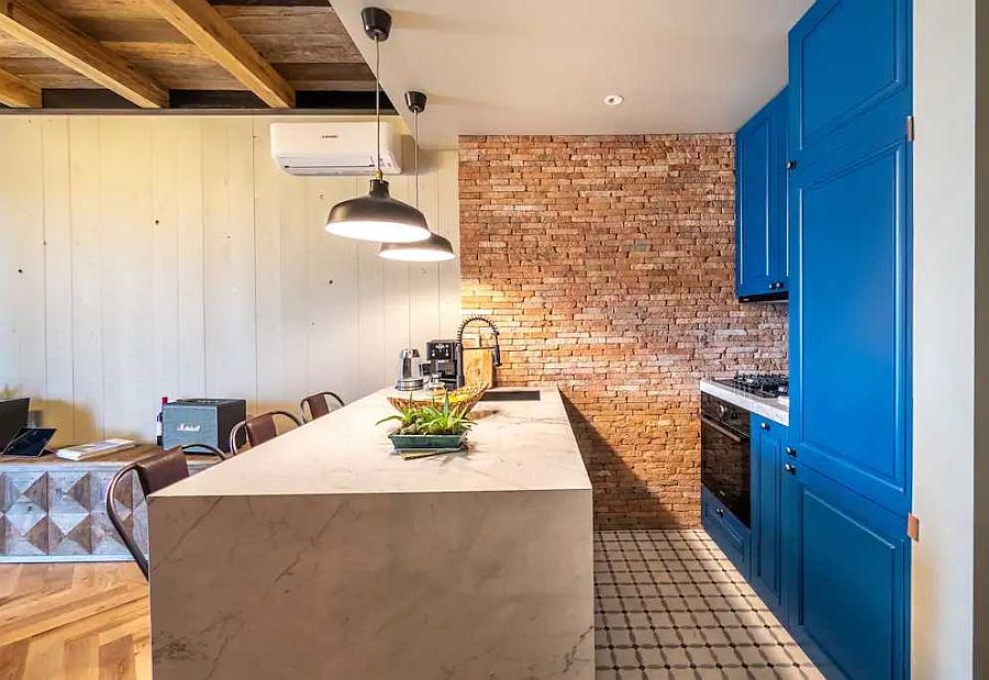 Kitchen at the end of the living area with a splash of blue thrown into mix