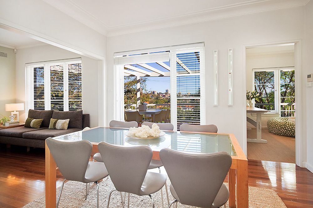 Light-filled dining room of the house is connected with the deck and outdoor dining space