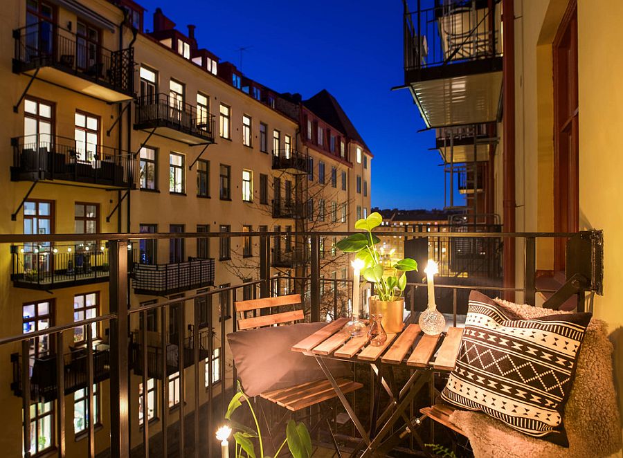 Lighting, flowers and a small bench along with couple of chairs turn the balcony into a romantic escape