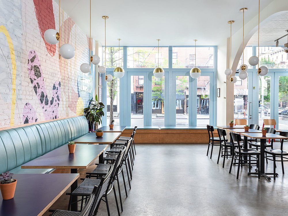 Lighting in white and gold brings a more classic design element to the cafe interior in New York City