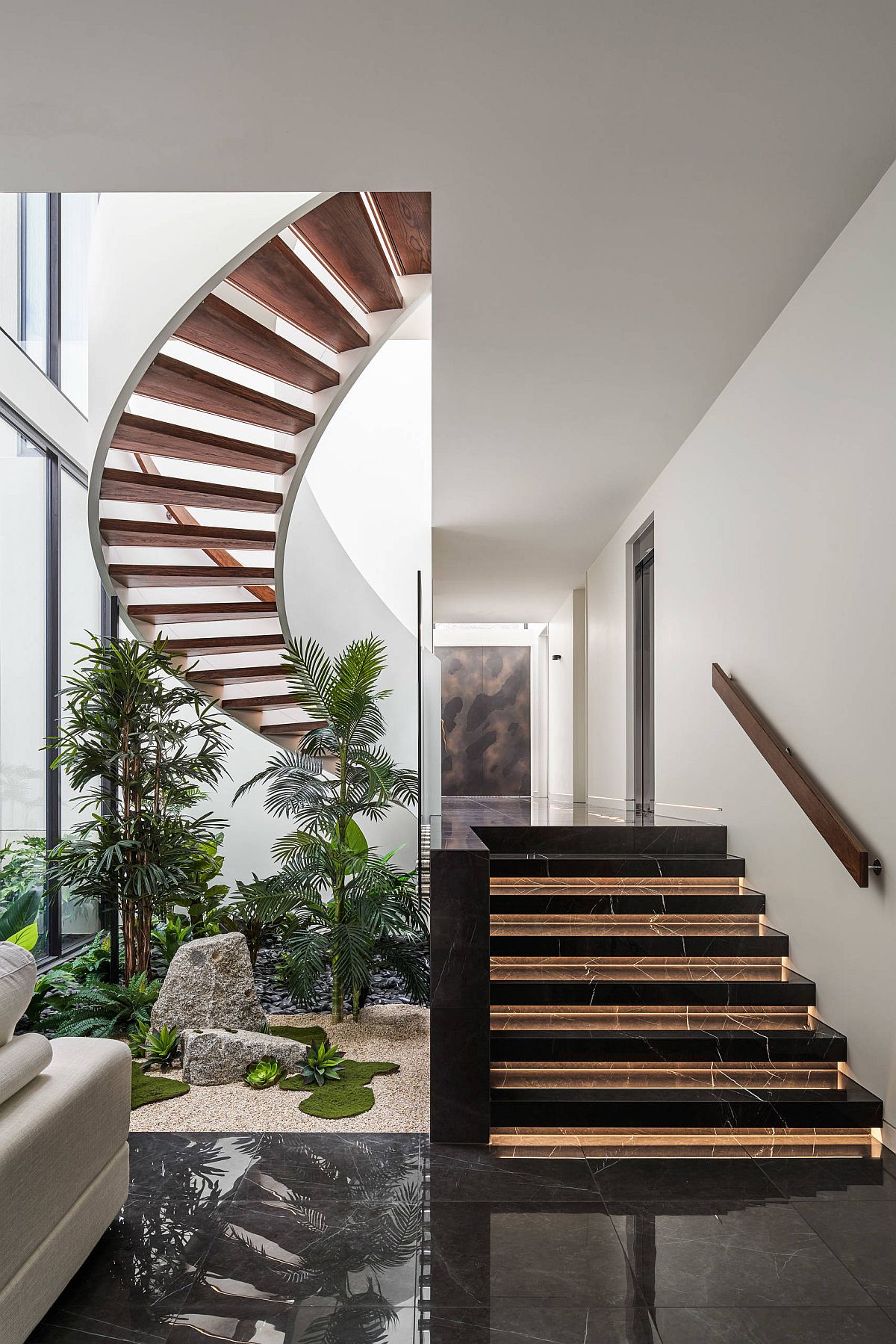 Lovely atrium in green along with a spiral staircase shapes this double-height entry