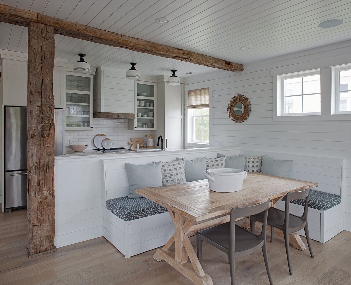 Lovely banquette seating for the beach style dining room saves space in style