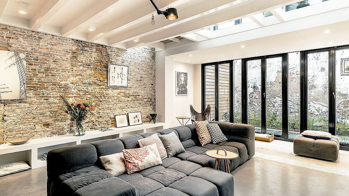 Luxurious sectional on the basement level creates a comfy sitting area