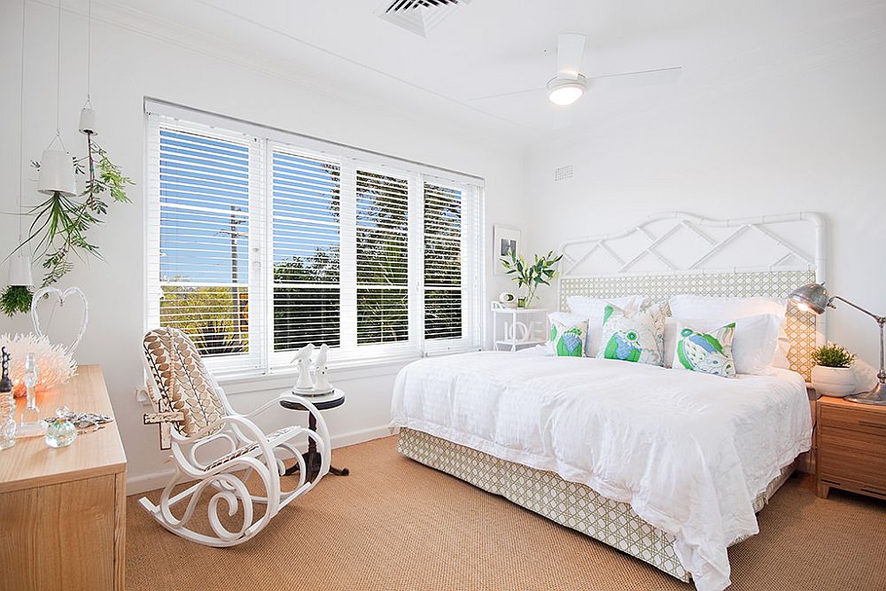 Master bedroom of the house in white and wood has a cozy, warm appeal and space-savvy design