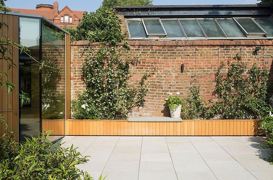 Modern oak and glass reading room of the London home showcases a smart renovation