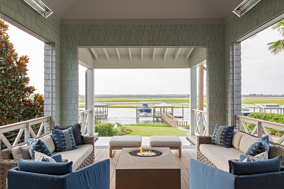 Modern porch with fireplace, blue sofas and ample shade