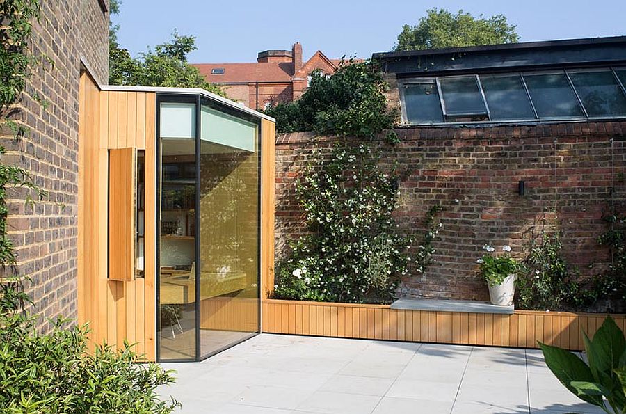 Oak and glass create a gorgeous reading room that extends into the small garden