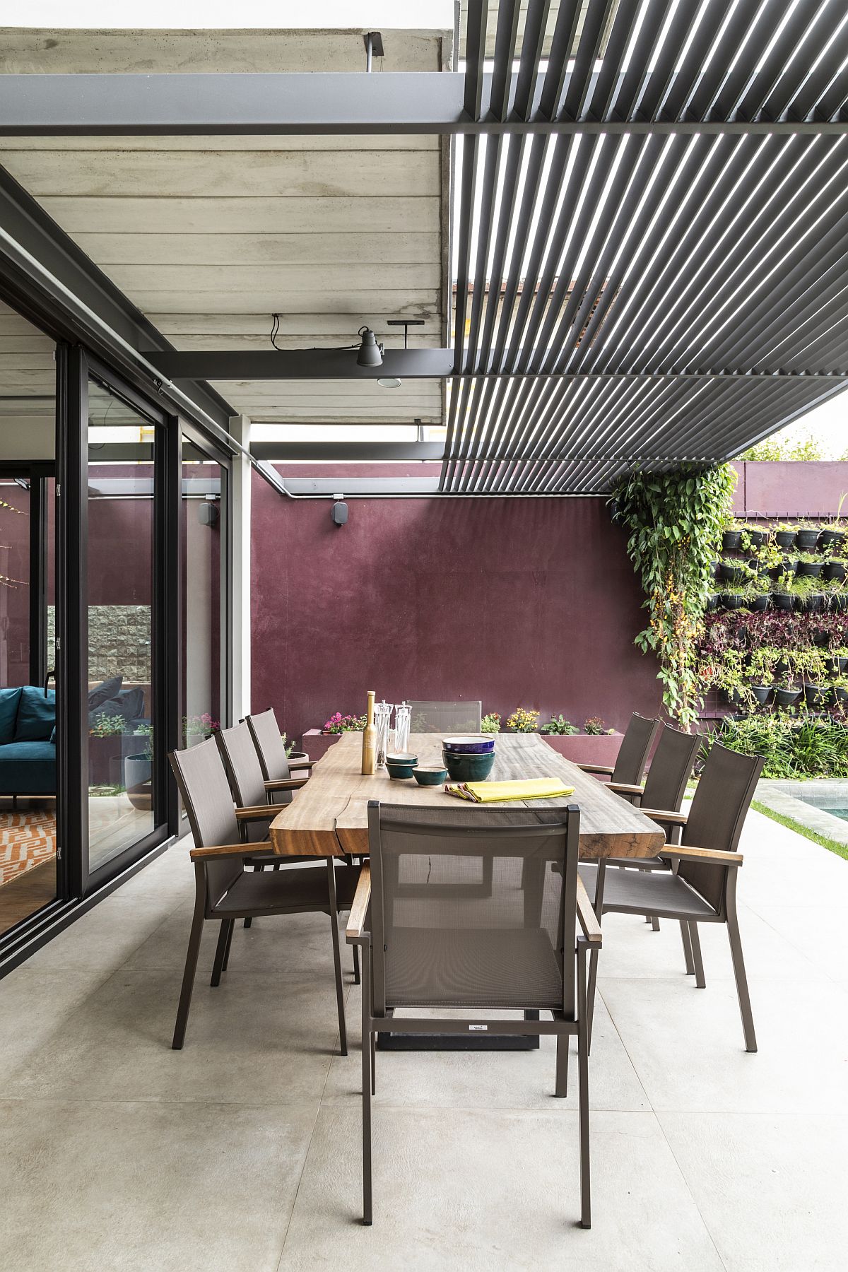 Outdoor covered dining area of the Brazilian home is connected with the living area