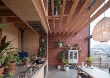 Pleasing-blend-of-warm-red-terracotta-bricks-and-wood-in-the-kitchen-with-a-metal-door-that-can-be-lifted-up-51936-217x155