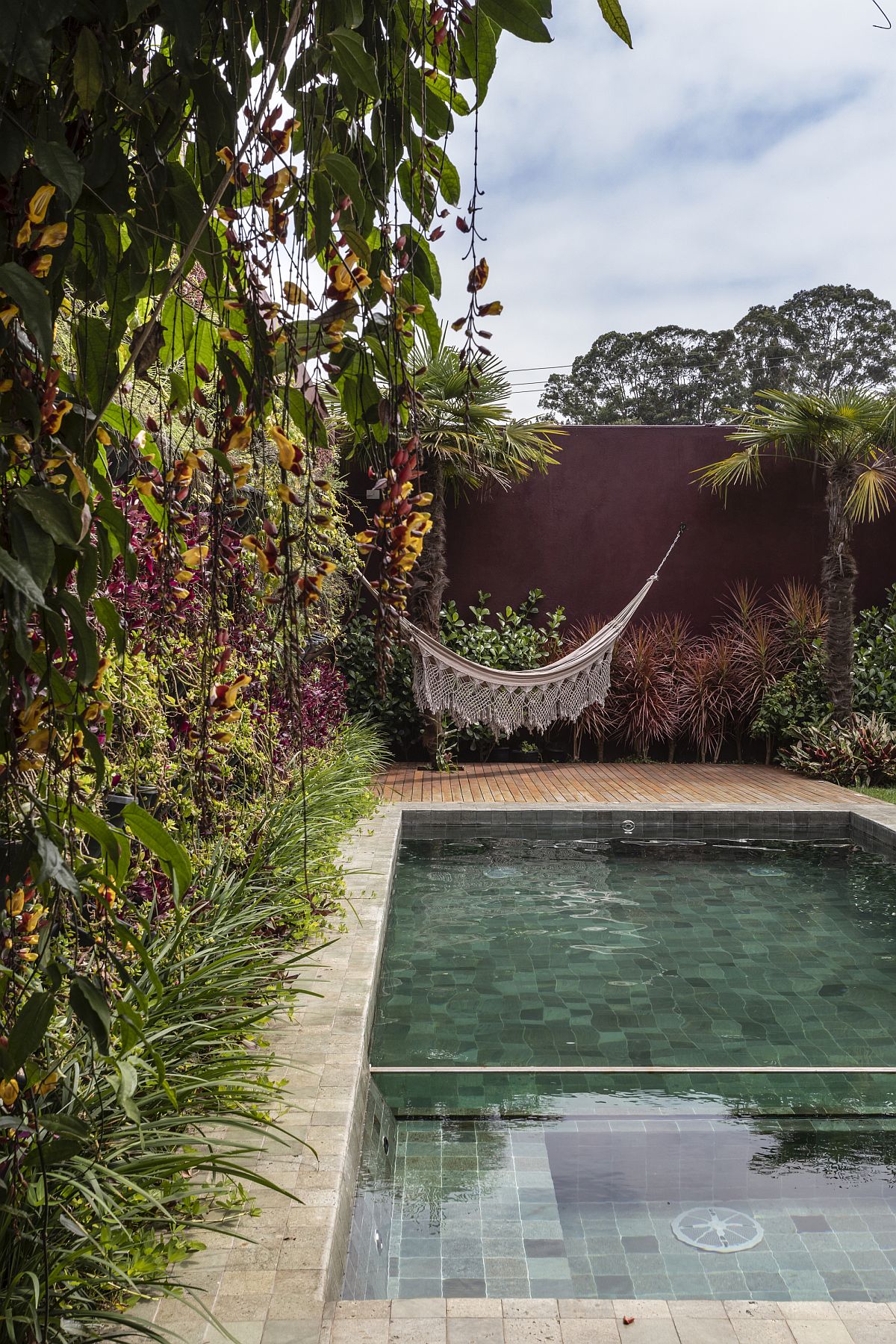 Relaxing-hammock-in-the-corner-next-to-the-pool-offers-a-serene-and-private-refuge-65780