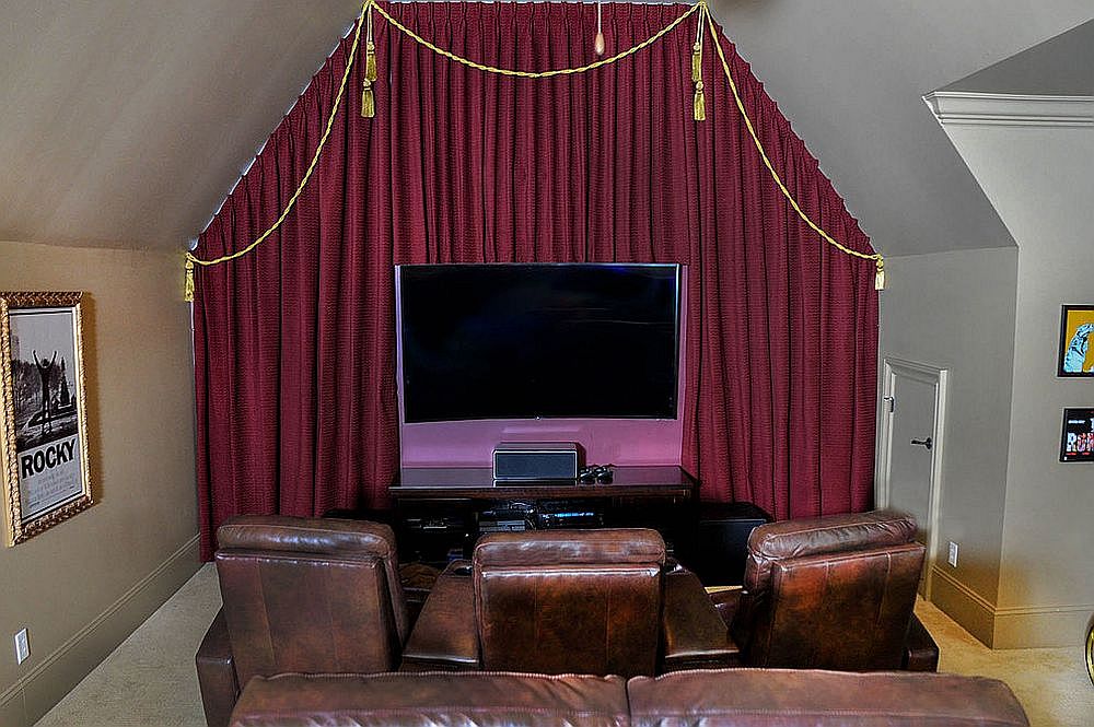 Selection of comfortable seats and screen turn the small room into a gorgeous home theater