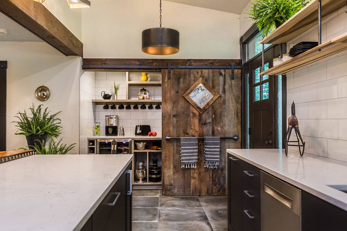 Sliding barn style door for the small industrial pantry in the spacious modern kitchen