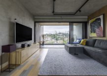Spacious-living-room-with-wooden-floor-and-concrete-ceiling-and-walls-35918-217x155