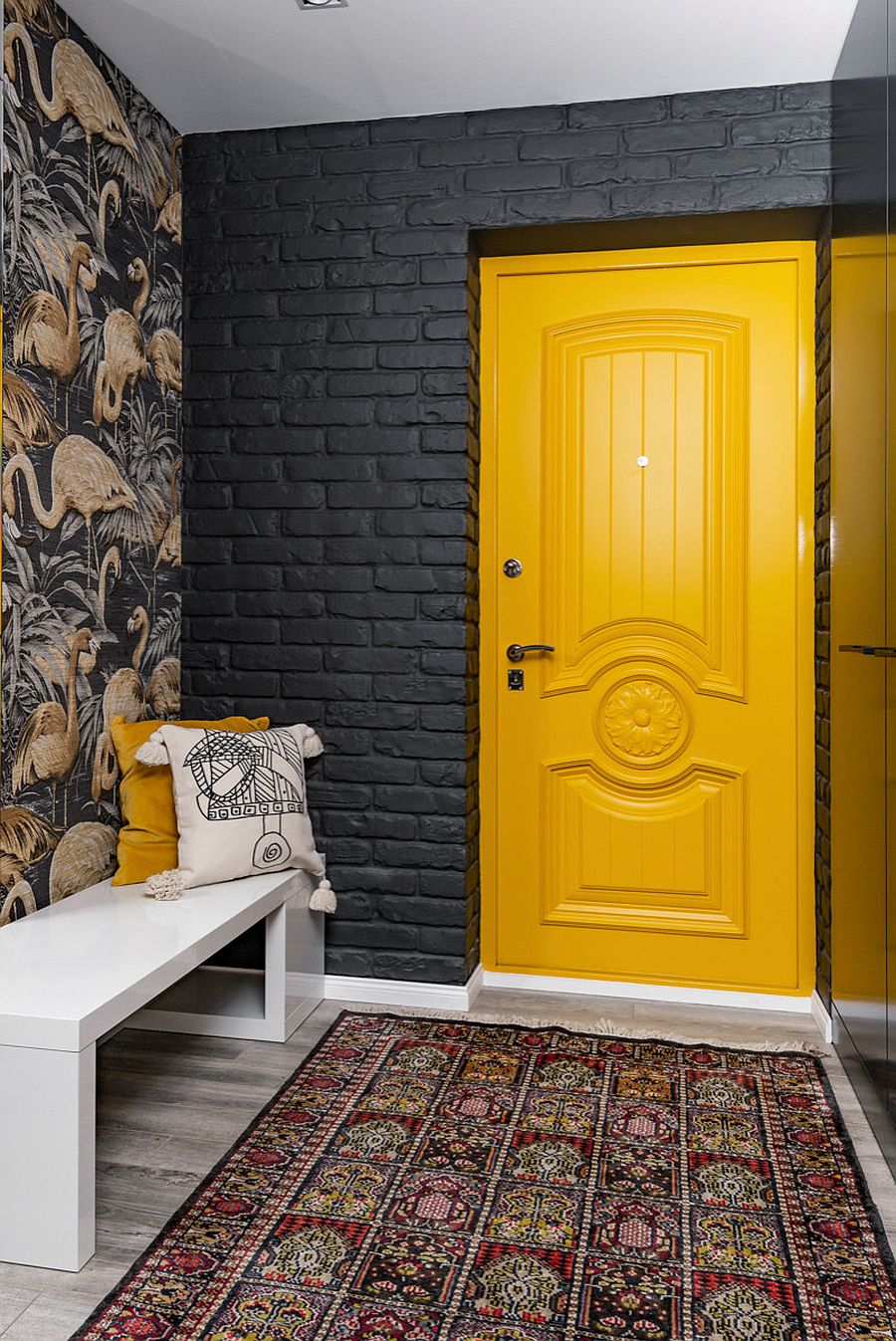 Striking yellow door makes the grandest visual statement in this dark and dashing contemporary entry