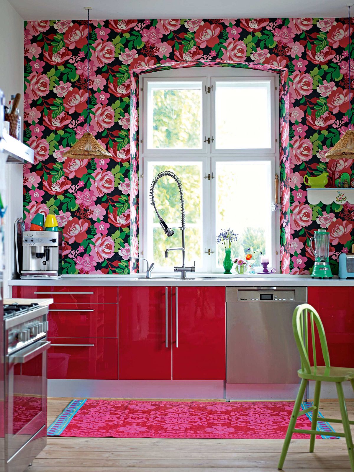 Stunning use of wallpaper with floral pattern in the modern eclectic kitchen with red cabinets