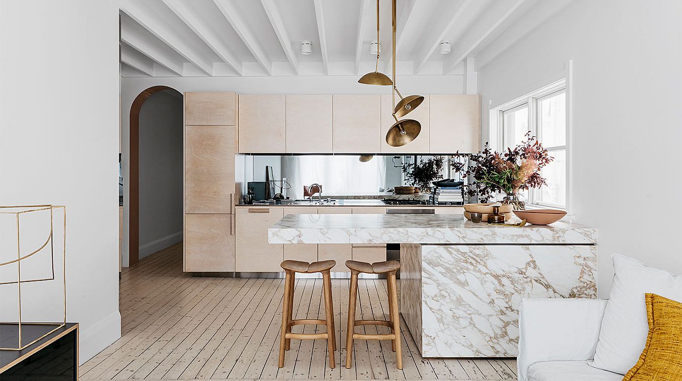 Stunningly beautiful kitchen of the beachside Sydney home with Calacatta Marble, wood and brass finishes all around