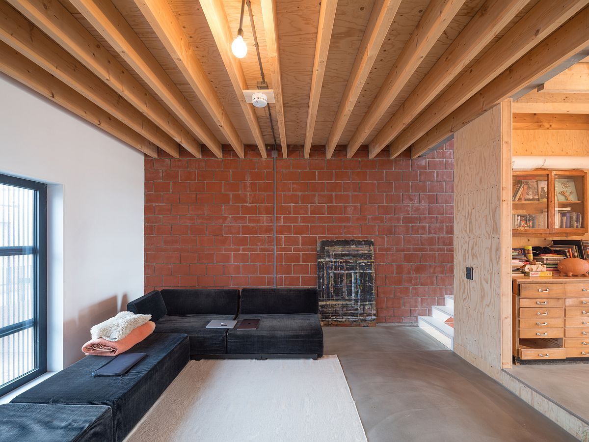 Terra cotta bricks and wood give the interior a unique and cozy appeal despite its modern style