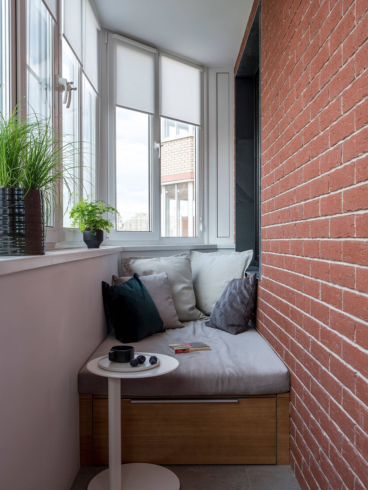 Tiny balcony of the home features a small seat at the end with storage below