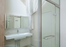 Triangular-cut-out-in-the-ceiling-brings-natural-light-into-the-small-bathroom-and-shower-area-14311-217x155