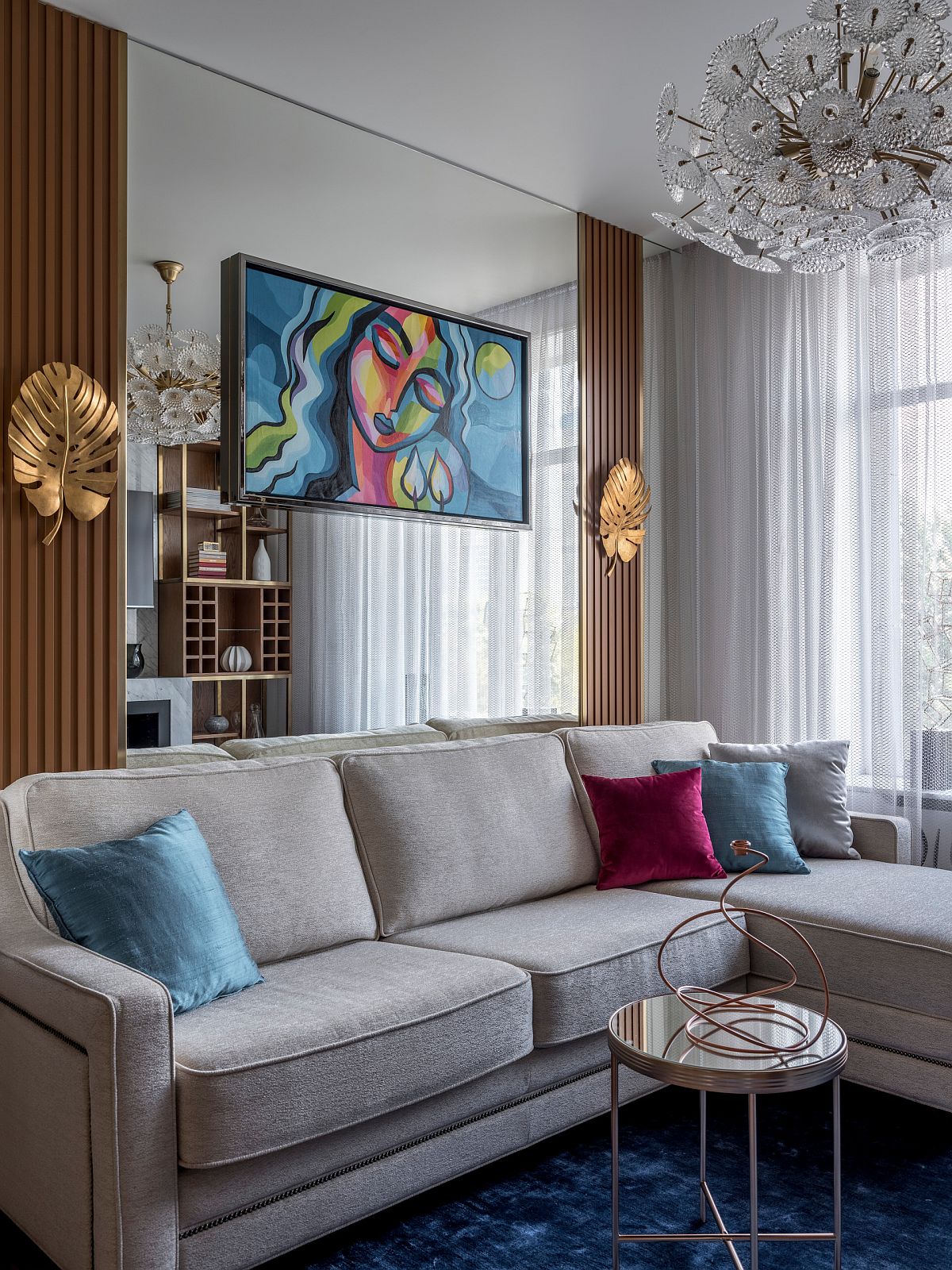 Using accent pillows in multple hues in the modern living room gives it a brighter vibe