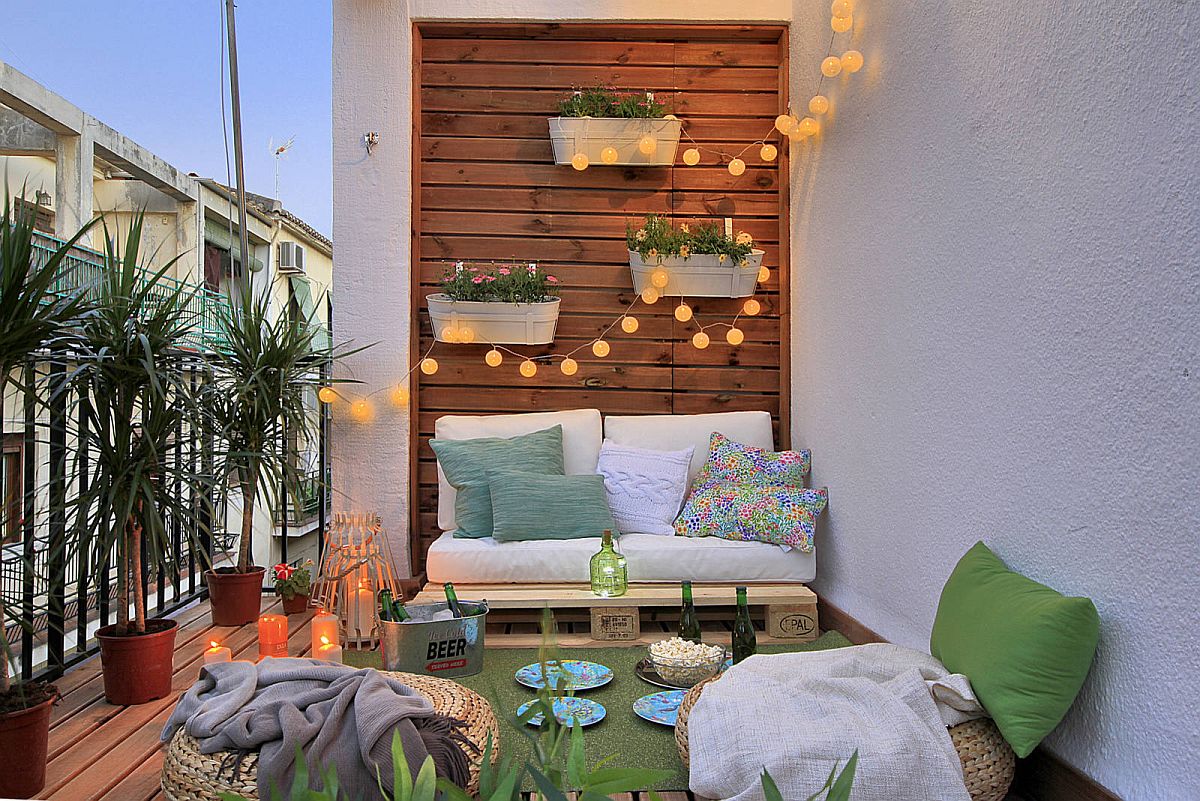 Wall-mounted planters coupled with string lights to shape a beautiful backdrop