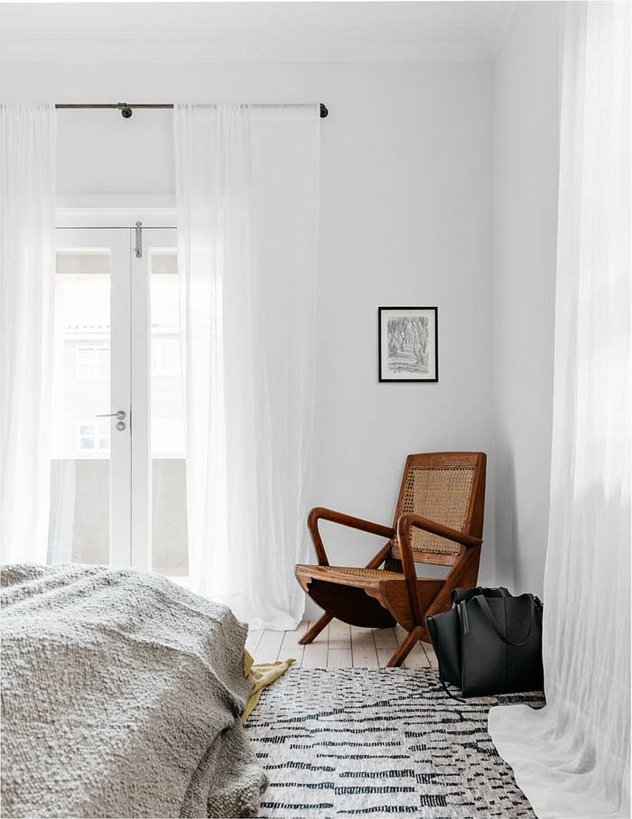 White sheer curtains in the bedroom bring an air of delicate luxury in the posh modern bedroom in white