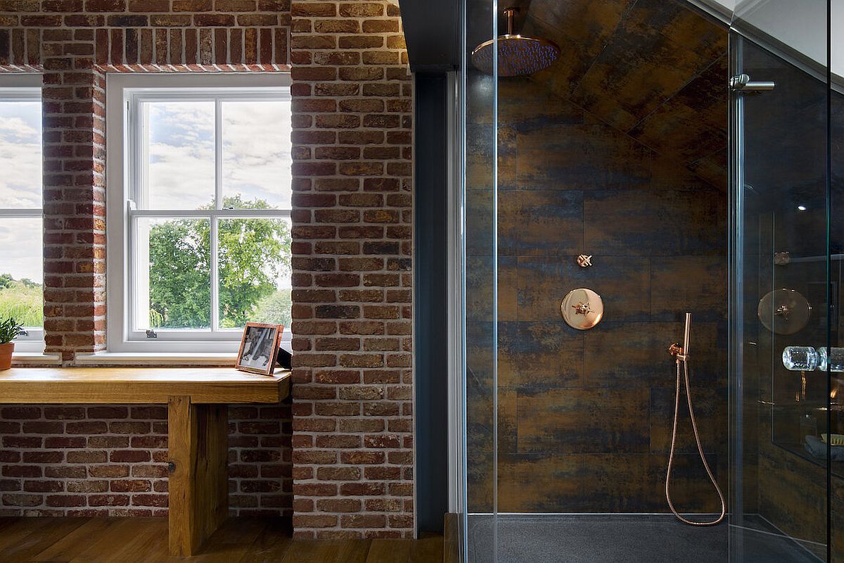 Wood, brick and glass sit next to one another inside this lavish master suite