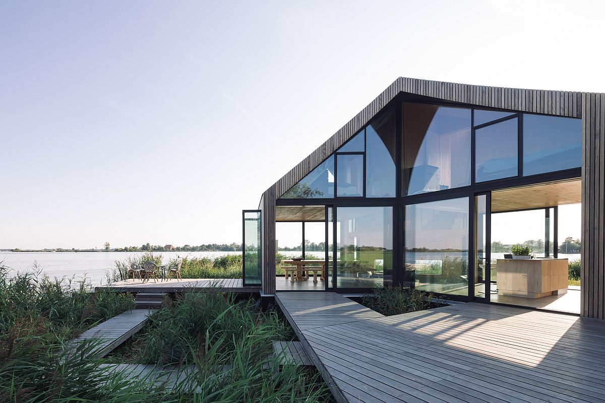 Wooden deck and large living area of the Dutch home with a view of outdoors