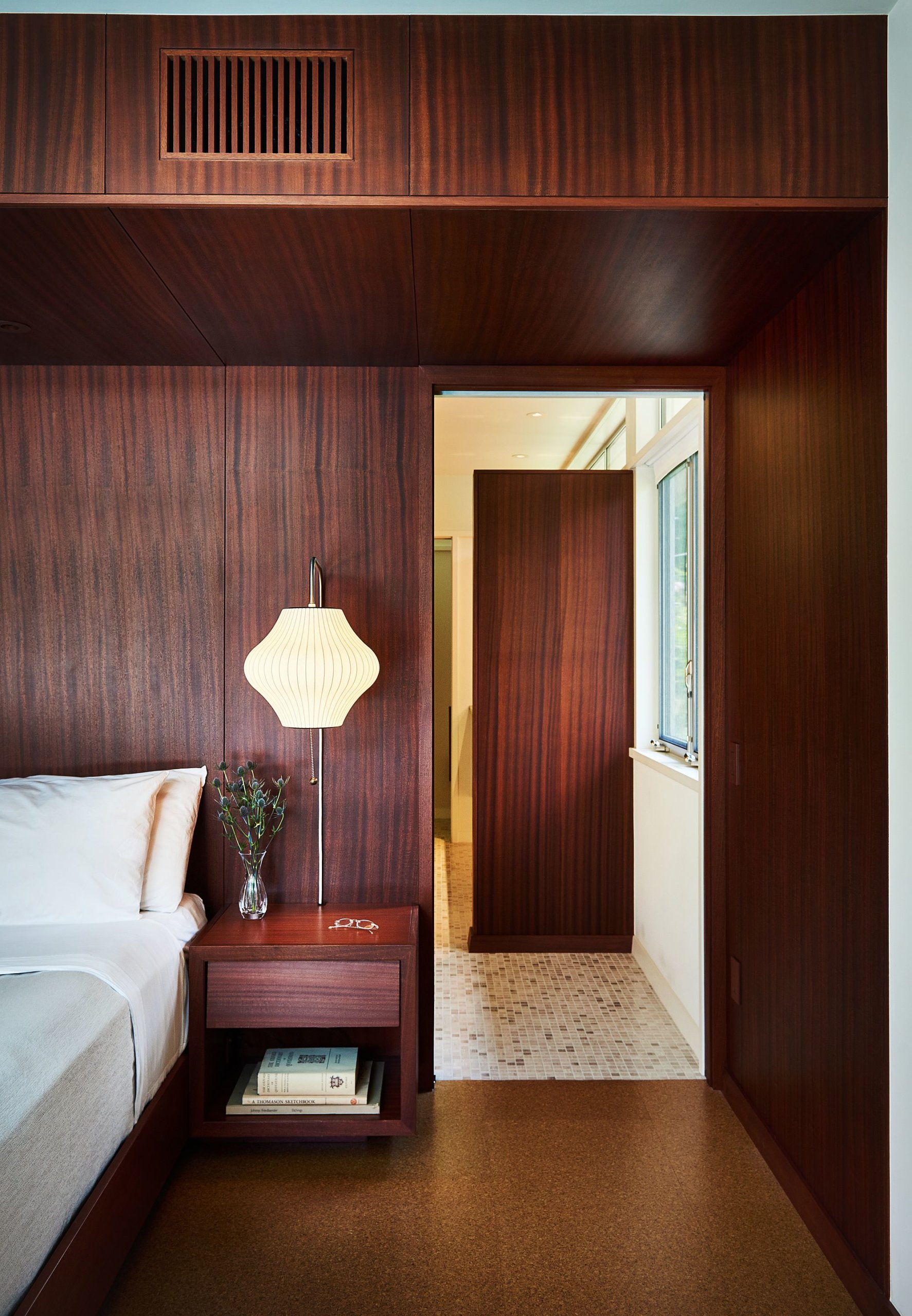 Bedroom walls draped in wood present a picture of opulence and midcentury modern appeal