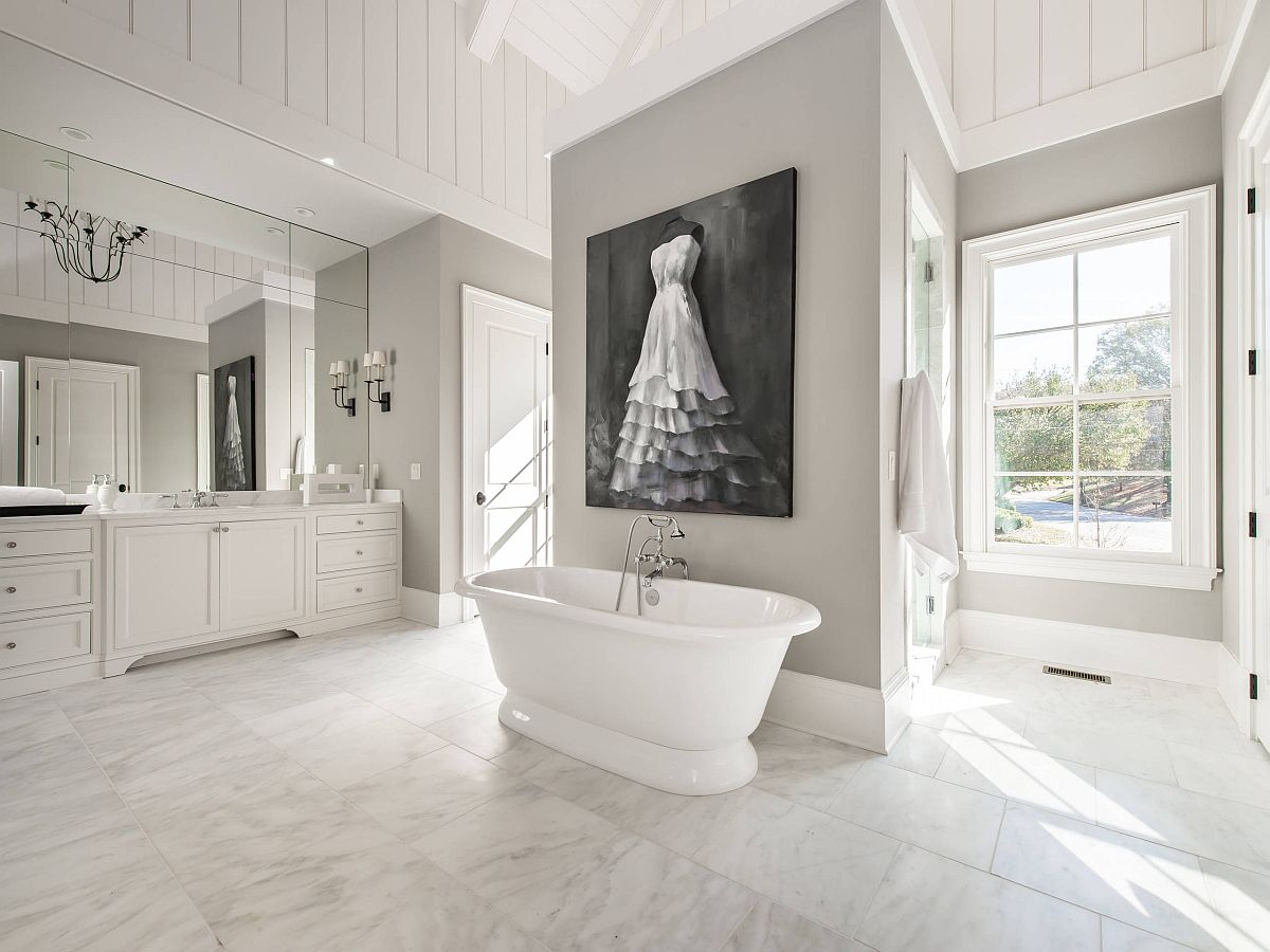 Black and white wall art piece blends in with the color scheme of this monochromatic bathroom