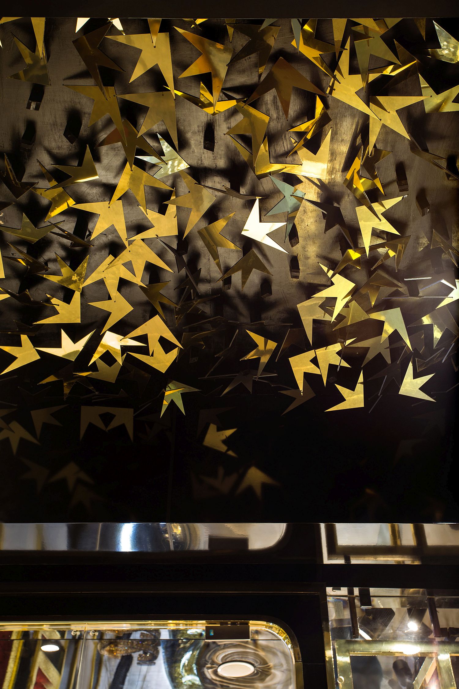 Black backdrop coupled with leaf-like design in gold welcomes you at the jewelry store