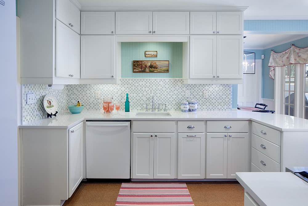 Blue and white modern kitchen with cork flooring that is easy on your eyes and feet!