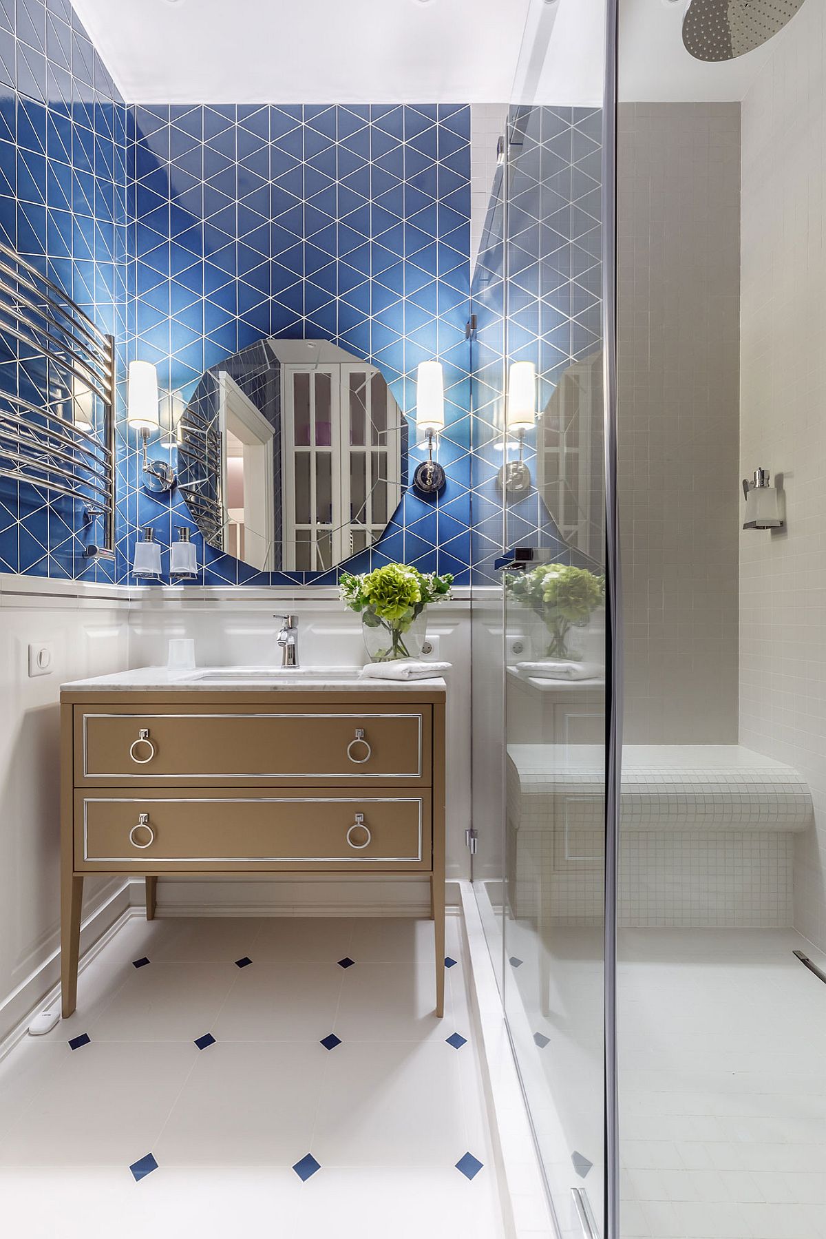 Blue tiles in the backdrop bring both color and pattern to this small white bathroom