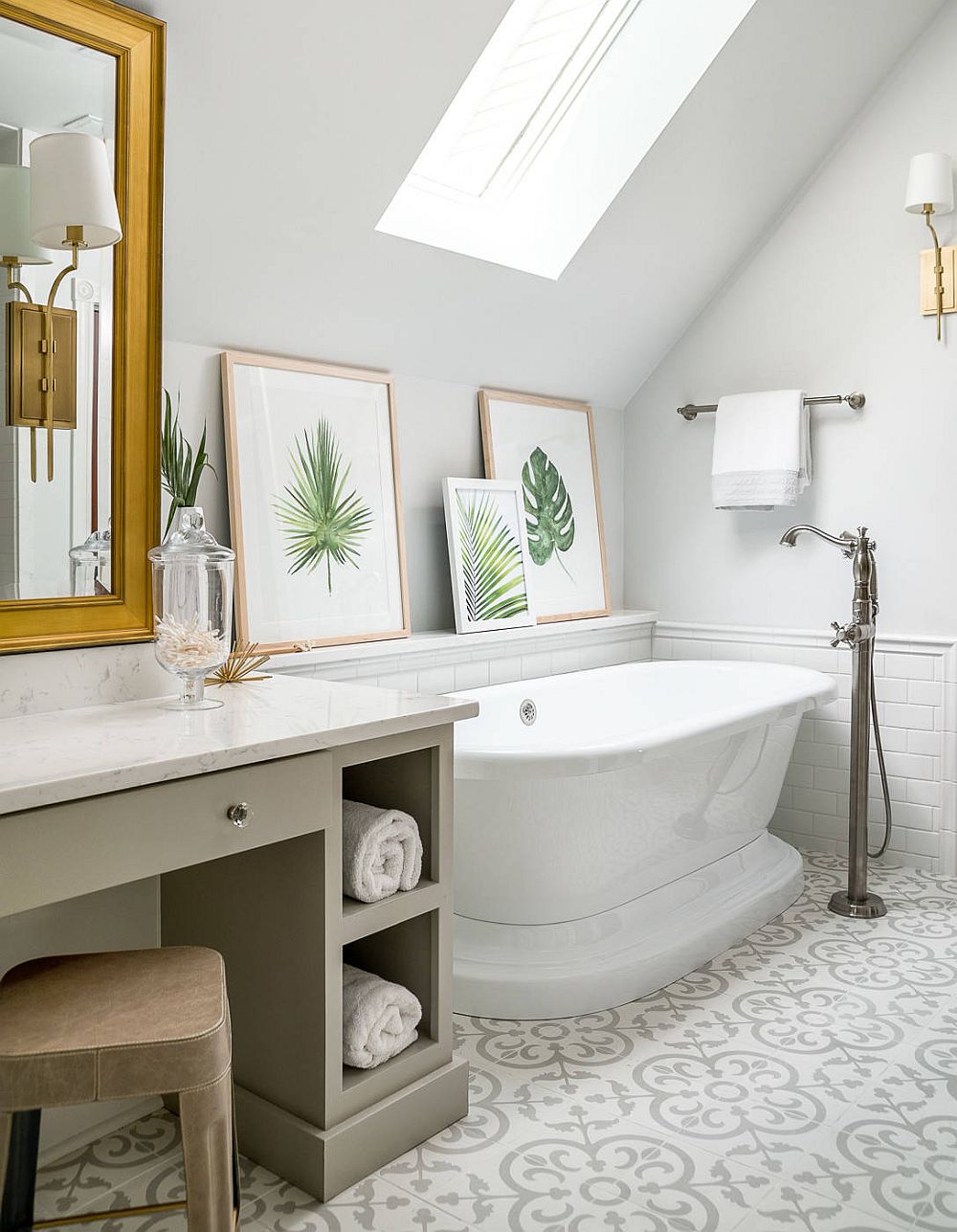 Brilliant use of framed botanicals on a ledge next to the freestanding bathtub in the revamped attic bathroom