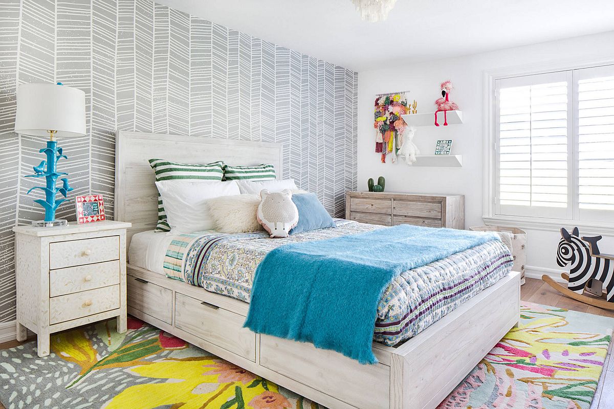 Carpet and bedding bring color into this neutral bedroom in gray full of pattern