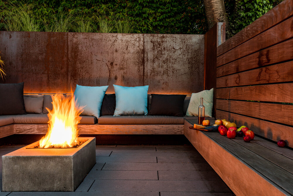 Cozy conversation pit with fireplace at its heart and a green wall all around