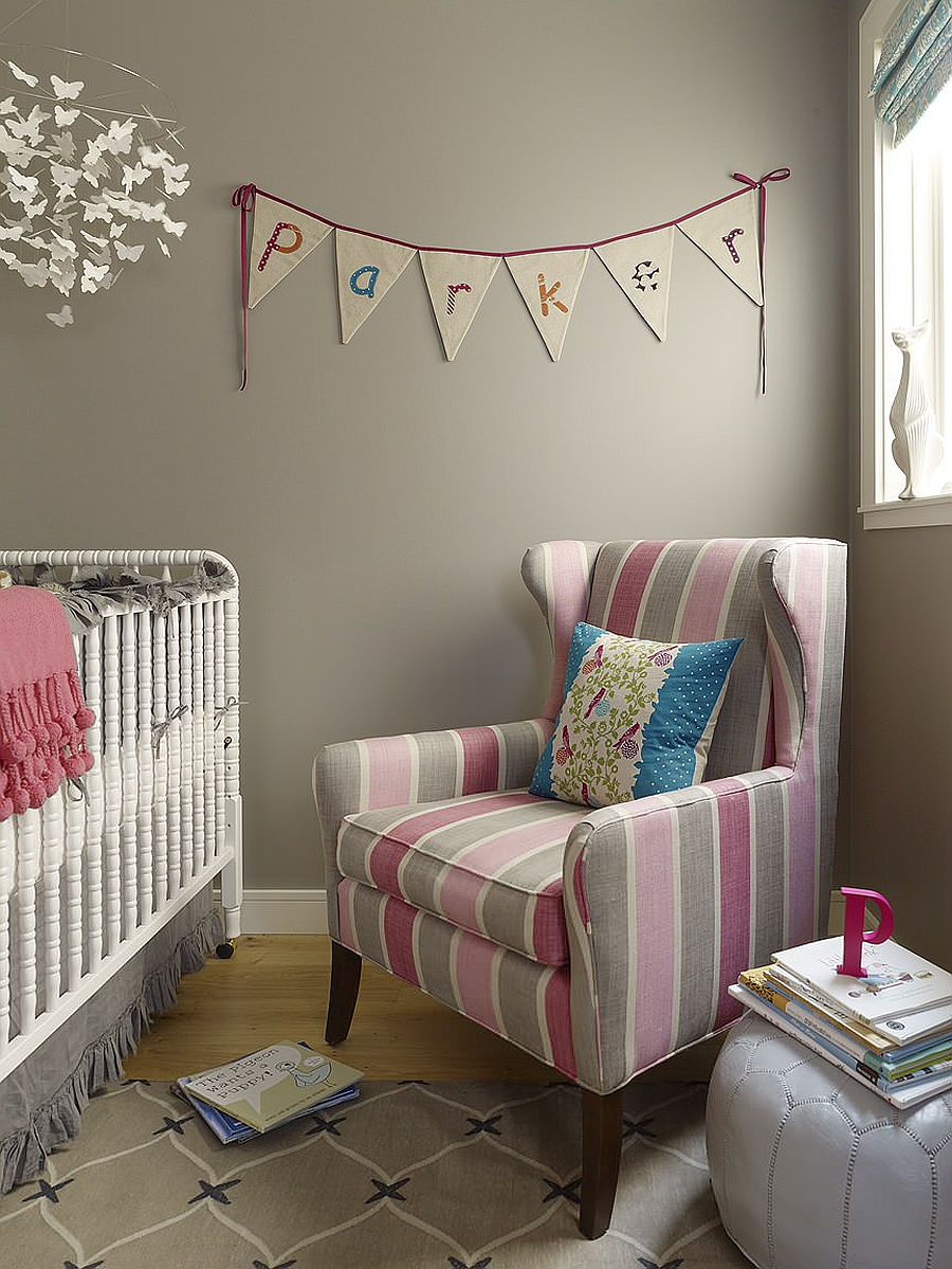 Custom chair with striped fabric adds color and contrast to this contemporary nursery