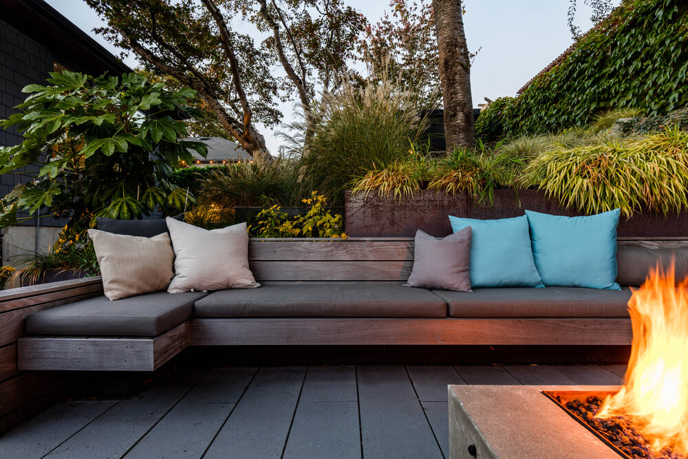 Custom ipe wood benches and cushions create a lovely outdoor sitting area