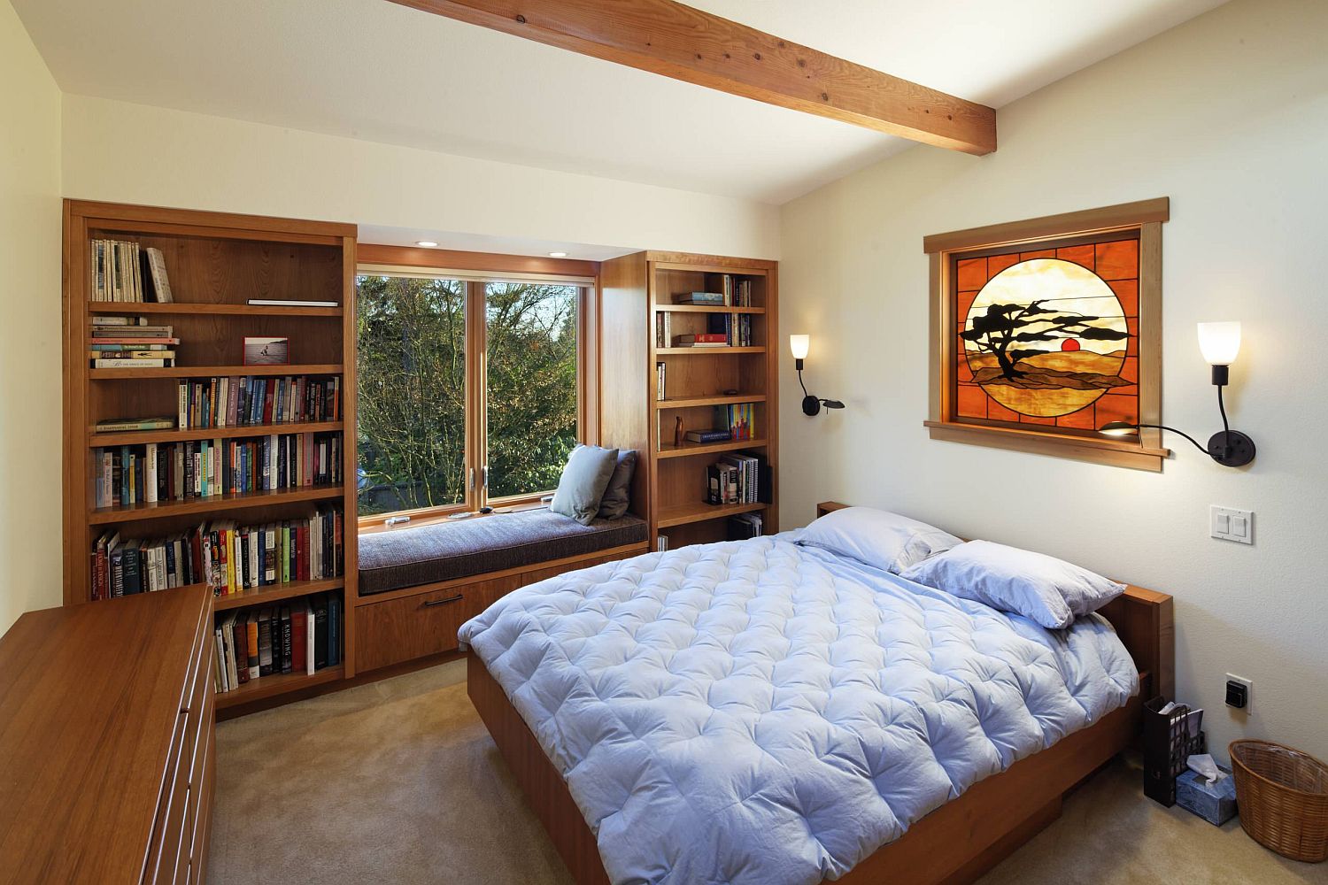 Custom window seat in wood with shelves next to it becomes the focal point of this traditional bedroom